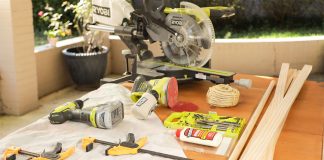 Ryobi and DeWalt power tools laid on an outdoor table