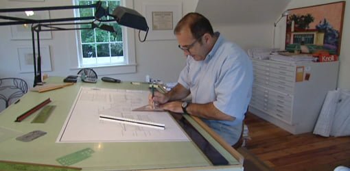 Architect working at drawing board.