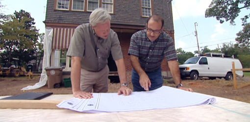 Danny Lipford going over plans on job site with architect.