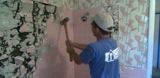 Pink bathroom wall tile demolition.