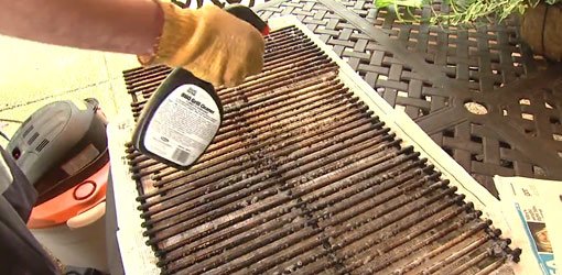 Cleaning the grates on a gas grill.