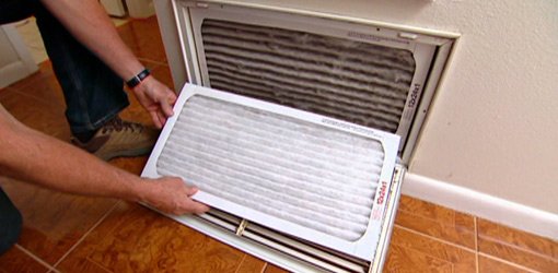Changing air conditioner air filter.