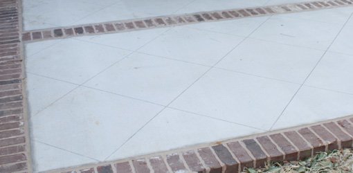 Patio floor after cleaning and scoring lines in concrete.