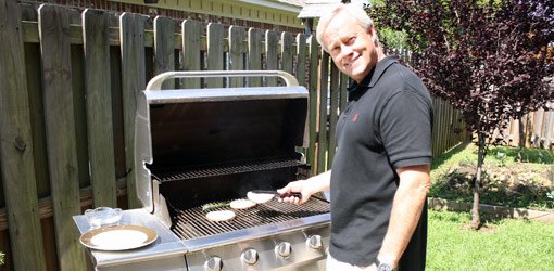 Danny Lipford grilling on a gas grill.
