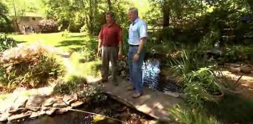 Allen and Danny standing on a bridge over a pond