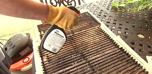 Using grill cleaner to clean the cooking grates on a gas grill.