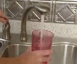 water pouring from a sink into a glass