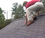 man on roof wearing cougar paws safety boots