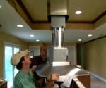 man installing kitchen ventillation hood
