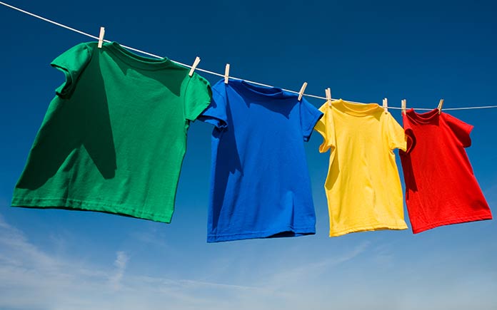 Vibrant clothes drying on a clothesline outside