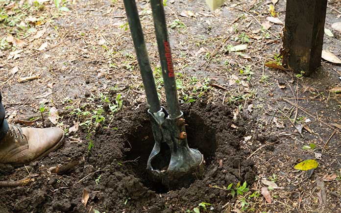 Digging a hole with a post hole digger
