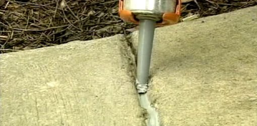 Caulk being applied to an expansion joint