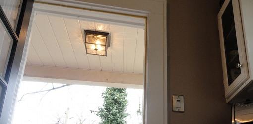 Timer switch on wall next to porch light