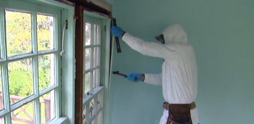 Protective suit and respirator worn when removing lead paint from house