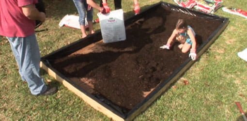 Filling raised planting bed with soil