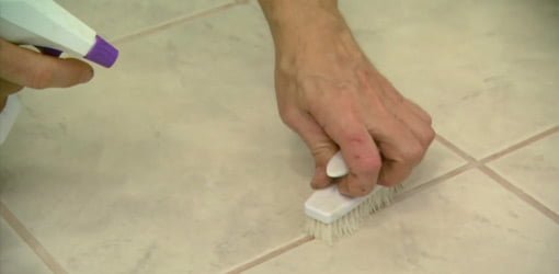 Cleaning grout lines with a scrub brush