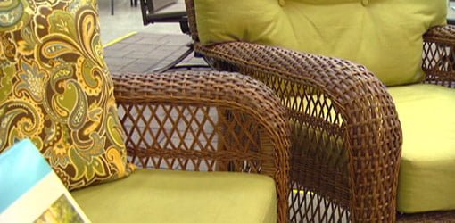 Brown synthetic wicker outdoor furniture with green cushions