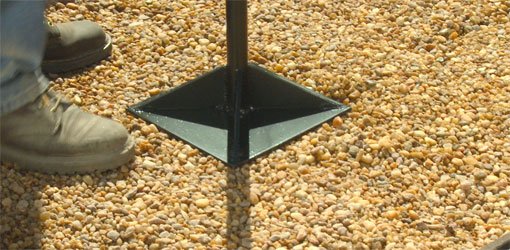 Using a tamp to compact gravel base