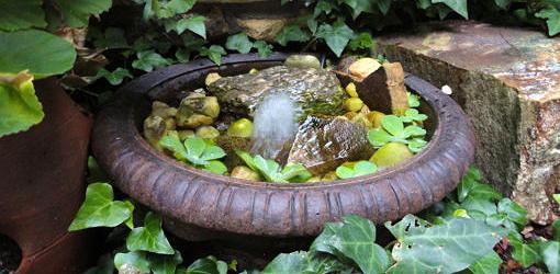 Water feature made from a recycled planter