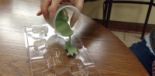 Pouring melted crayon wax into plastic mold