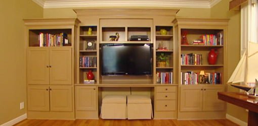 Built-in bookcase painted an beige color similar to the walls