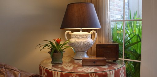 Plant, lamp, and boxes arranged on a table