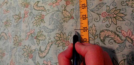 Measuring fabric with tape measure