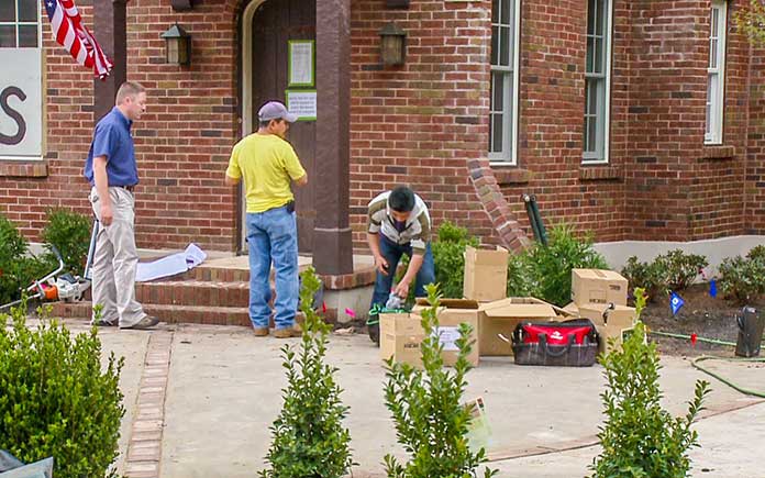 Men install landscaping in Mobile, Alabama