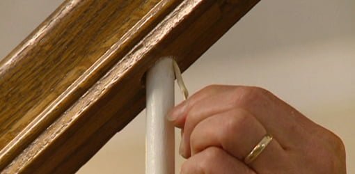 Repairing a loose staircase baluster spindle using a toothpick and wood glue.