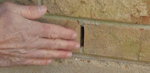 Weep hole in brick wall