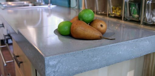 Concrete countertop with fruit on it.