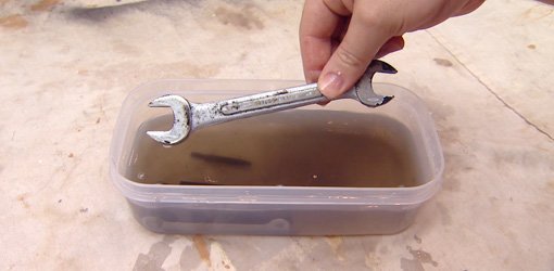Wrench soaking in Metal Rescue Liquid Rust Remover