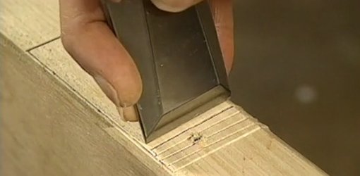 Cutting a door hinge mortise with a chisel.
