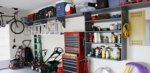 Completed garage organization project with new shelving and storage.