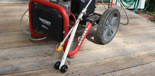 Pressure washer wand roller guide made from PVC pipe and casters.