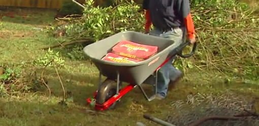 Hauling bags of concrete in the True Temper Poly Wheelbarrow with Total Control Handles