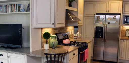 Kitchen with gas stove and range hood.