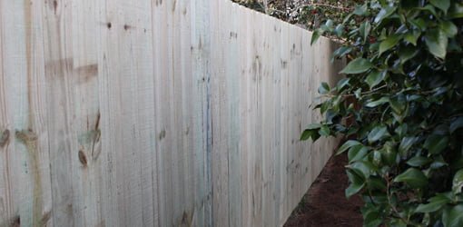 Completed pressure treated wood privacy fence.