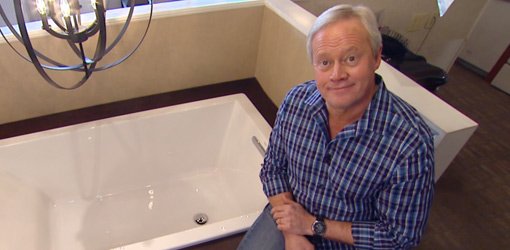 Danny Lipford in bathroom showroom with tub.