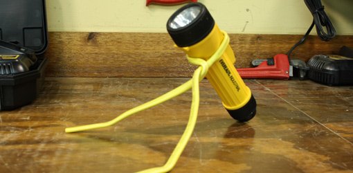 Flashlight stand made from electrical cable.