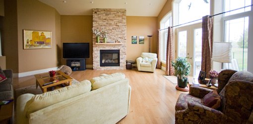 Living room with fireplace and wall of windows.