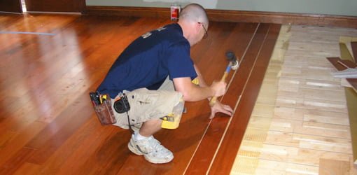 Installing hardwood flooring over a radiant heating system.