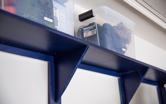 plastic storage bins on a blue shelf