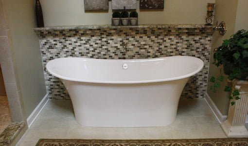 Master bathroom soaking tub with tile wall behind it after renovation.
