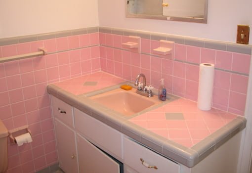 Bathroom with pink tile walls and vanity top.