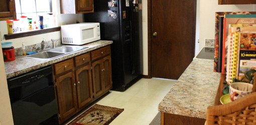 Minor kitchen makeover included refinishing cabinets and countertops.
