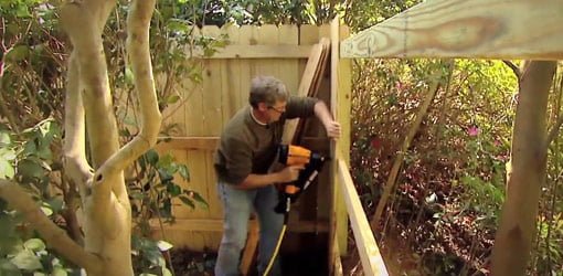 Attaching stringers to posts when building a wooden fence.