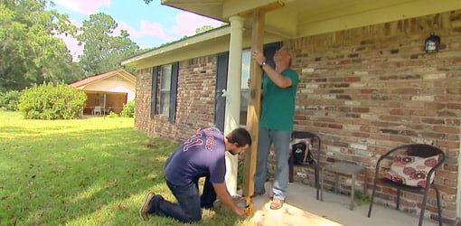 Homeowner Hunter Black and Danny Lipford jacking up rotten porch columns.