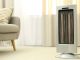 Electric space heater blowing warm air into stylish modern living room