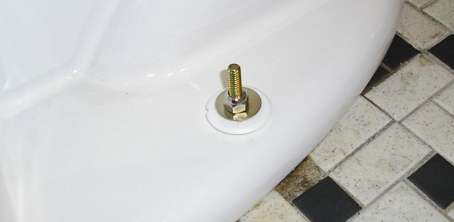 Toilet flange bolt with washer and nut installed.